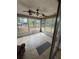Enclosed porch featuring tile flooring, ceiling fans, and windows overlooking the backyard at 333 Marion Oaks Dr, Ocala, FL 34473
