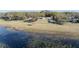 Aerial view of lakefront property with dock, revealing a tranquil setting surrounded by natural beauty at 390 Sw Shorewood Dr, Dunnellon, FL 34431