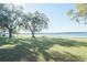 Lakeside home with a sprawling lawn, mature trees, and a private dock, ideal for outdoor activities and enjoying nature at 390 Sw Shorewood Dr, Dunnellon, FL 34431