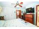 Bedroom with light walls, ceiling fan, spacious closet, and a dresser for storage at 390 Sw Shorewood Dr, Dunnellon, FL 34431