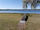 Charming waterfront property with a sturdy wooden dock offering direct access to the serene lake for recreation and relaxation at 390 Sw Shorewood Dr, Dunnellon, FL 34431