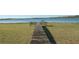 Waterfront property showcasing a private dock with a built-in bench, offering a perfect spot to relax and enjoy the serene lake views at 390 Sw Shorewood Dr, Dunnellon, FL 34431