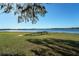 Lakeside retreat featuring a wooden dock with a bench, boat, and lush grassy lawn, offering serene waterfront living at 390 Sw Shorewood Dr, Dunnellon, FL 34431