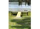 Picturesque wooden dock extends over the lake's edge, offering serene waterfront views at 390 Sw Shorewood Dr, Dunnellon, FL 34431