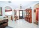Bright entryway featuring white tile flooring and classic wood furniture at 390 Sw Shorewood Dr, Dunnellon, FL 34431
