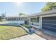 Inviting single-story home with a neatly landscaped front yard and an attached garage at 390 Sw Shorewood Dr, Dunnellon, FL 34431