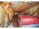 Garage interior showcasing ample storage space with exposed rafters and a classic red car at 390 Sw Shorewood Dr, Dunnellon, FL 34431