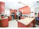 Well-lit kitchen area with stainless steel appliances, cherry wood cabinets, and laminate countertops at 390 Sw Shorewood Dr, Dunnellon, FL 34431