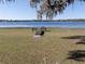 Scenic lake view highlighting a private wooden dock perfect for fishing, boating, or simply enjoying the natural surroundings at 390 Sw Shorewood Dr, Dunnellon, FL 34431