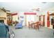 Cozy living room featuring a fireplace, ceiling fan, and access to a dining area at 390 Sw Shorewood Dr, Dunnellon, FL 34431