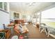 Enclosed patio with hot tub, ceiling fan, furniture and lake views at 390 Sw Shorewood Dr, Dunnellon, FL 34431