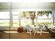 Screened-in porch featuring scenic lake views, offering a tranquil outdoor living space at 390 Sw Shorewood Dr, Dunnellon, FL 34431
