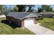 Aerial of this beautiful home showing brick facade, attached garage, and a well-maintained lawn at 4541 Sw 44Th Ln, Ocala, FL 34474