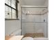 Tiled walk-in shower with glass doors in renovated bathroom with window at 4541 Sw 44Th Ln, Ocala, FL 34474