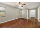 Bedroom with wood floors, ceiling fan, and a closet with ample storage at 4541 Sw 44Th Ln, Ocala, FL 34474