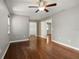 Bedroom featuring hardwood floors, ceiling fan, and attached walk-in closet at 4541 Sw 44Th Ln, Ocala, FL 34474