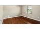Bedroom with hardwood floors and large window with blinds at 4541 Sw 44Th Ln, Ocala, FL 34474