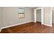 Bedroom featuring hardwood floors, window, and closet space at 4541 Sw 44Th Ln, Ocala, FL 34474