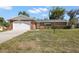 Charming brick home features an attached two-car garage and well-maintained front lawn at 4541 Sw 44Th Ln, Ocala, FL 34474