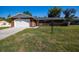 This charming brick home features an attached two-car garage and a well-maintained front lawn at 4541 Sw 44Th Ln, Ocala, FL 34474
