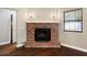 Brick fireplace with decorative lighting and wood flooring at 4541 Sw 44Th Ln, Ocala, FL 34474