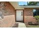 Close up of the front door of the home, complete with brick facade and landscaped entrance at 4541 Sw 44Th Ln, Ocala, FL 34474