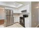 Kitchen boasts stainless steel refrigerator and black range oven at 4541 Sw 44Th Ln, Ocala, FL 34474
