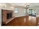 Charming living room features brick fireplace and access to sunroom at 4541 Sw 44Th Ln, Ocala, FL 34474