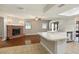 Open-concept living room combines kitchen and fireplace with sunroom access at 4541 Sw 44Th Ln, Ocala, FL 34474