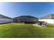 Spacious backyard features well-maintained lawn, privacy fence and an outdoor patio set at 5001 Sw 91St Pl, Ocala, FL 34476