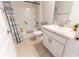 Bright bathroom features a shower and tub combination and neutral ceramic tile flooring at 5001 Sw 91St Pl, Ocala, FL 34476