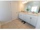 Bright bathroom with tile flooring, a double sink vanity and a large mirror at 5001 Sw 91St Pl, Ocala, FL 34476