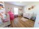 Charming bedroom with wood flooring and white furniture, perfect for a room at 5001 Sw 91St Pl, Ocala, FL 34476