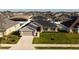 Charming single-story home featuring a well-manicured lawn, attached two-car garage and dark-grey roof at 5001 Sw 91St Pl, Ocala, FL 34476