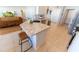 Modern kitchen with island seating, stainless steel appliances and open layout to the living area at 5001 Sw 91St Pl, Ocala, FL 34476