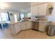 Bright eat-in kitchen with white cabinets, stone countertops, stainless steel appliances and a dining area at 5001 Sw 91St Pl, Ocala, FL 34476