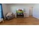 Comfortable living room with luxury vinyl plank flooring, fireplace, and large windows at 5001 Sw 91St Pl, Ocala, FL 34476