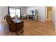 Bright living room with new floors, comfortable seating, and an open view to the bathroom at 5001 Sw 91St Pl, Ocala, FL 34476