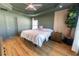 Bedroom featuring a ceiling fan, wood flooring, neutral paint, and bright windows at 5001 Sw 91St Pl, Ocala, FL 34476