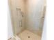 Beautiful glass enclosed shower with neutral tile, a shower caddy and a handheld shower head at 5001 Sw 91St Pl, Ocala, FL 34476