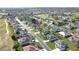 Stunning aerial view of the house nestled in a vibrant community, with tree-lined streets and lush green lawns at 5291 Nw 20 Pl, Ocala, FL 34482