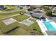 Great aerial showing the community pool, shuffleboard, and tennis courts, promising endless fun at 5291 Nw 20 Pl, Ocala, FL 34482