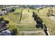 Expansive golf course views with manicured greens, mature trees, and a tranquil pond, inviting residents to play at 5291 Nw 20 Pl, Ocala, FL 34482