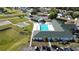Aerial view of community amenities: Pool, shuffleboard, tennis courts, and community center, providing a wealth of activities at 5291 Nw 20 Pl, Ocala, FL 34482