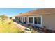 Lovely backyard showcasing a covered lanai, lush landscaping, and a brick pathway, ideal for outdoor gatherings at 5291 Nw 20 Pl, Ocala, FL 34482