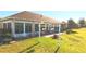 Spacious backyard boasts a screened lanai and meticulously maintained landscaping, perfect for relaxing and entertaining at 5291 Nw 20 Pl, Ocala, FL 34482