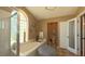 Bright bathroom features soaking tub, walk-in shower, and neutral color palette at 5291 Nw 20 Pl, Ocala, FL 34482