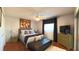 Cozy bedroom features hardwood floors, a ceiling fan, and natural light at 5291 Nw 20 Pl, Ocala, FL 34482