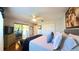 Spacious bedroom features hardwood floors, a ceiling fan, and sliding glass doors at 5291 Nw 20 Pl, Ocala, FL 34482