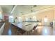 Bright community center room with tables, chairs, ceiling fans, and natural light from large windows at 5291 Nw 20 Pl, Ocala, FL 34482